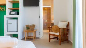 a living room with two chairs and a refrigerator at Cava del Mare in Favignana