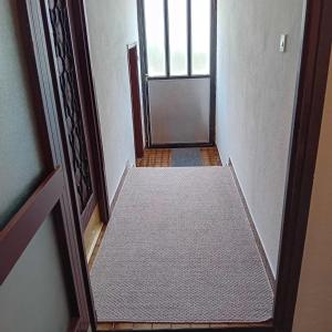 an empty hallway with a door leading to a room at Kuca za prespavati in Bihać