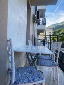 a table and chairs on a balcony with a view at BIJELA apartman 2025 in Bijela