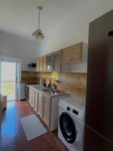 a kitchen with a washer and a washing machine at Village Memories in Koronópoulon