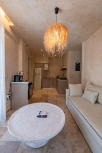 a living room with a couch and a table at Terra Elea Luxury Pool Suite Aura in Nikiti