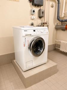 a washer and dryer sitting in a room at City Center Studio Pori in Pori