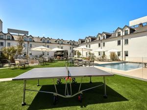 a ping pong table in front of a building at ibis La Roche Sur Yon Vendespace in Mouilleron-le-Captif