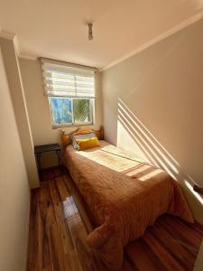 a small bedroom with a bed and a window at Departamento Amplio y tranquilo in Talca +20 photos