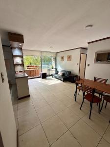 a large living room with a table and a kitchen at Departamento Amplio y tranquilo in Talca