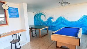 a pool table in a room with a mural at Oceans Whisper 704 beach apartment gated & Lift access in Scottburgh
