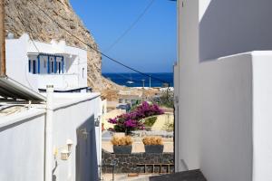 a view from a balcony of a house with flowers at Angelo Boutique Hotel Santorini in Perissa