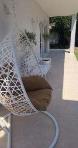 a white swing with a pillow on a patio at Boutique Villa Sofia in Limenas