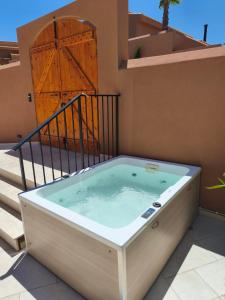 a hot tub on the side of a house at Arcasa Villas Collection by Omilos Hotels in Archanes