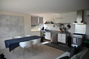 a kitchen with a table and chairs in a kitchen at Gîte du Mont Gérard in La Lanterne-et-les-Armonts