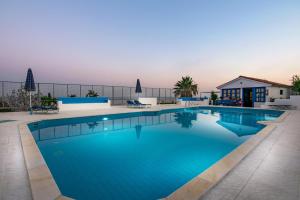 a large swimming pool with blue water at Creta Sky in Achlia