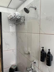 a bathroom with a shower with a glass door at Hotel Vishwaraj Residency in Solapur +10 photos