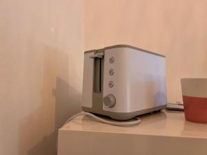 a toaster sitting on top of a counter with a cup at Alessandra guest house in Alghero