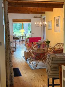a living room with chairs and a dining room at Havsnära fritidshus in Åhus