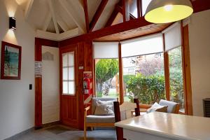 a kitchen with a large window and a table and chairs at Los Techos Apart in Esquel