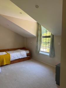 a attic bedroom with a bed and a window at Meadows Hotel in Perranzabuloe