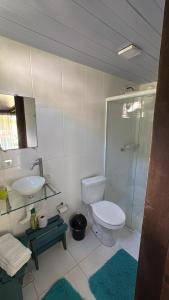 a bathroom with a toilet and a sink and a shower at Recanto do Sol II in Ilha do Mel