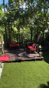 two chairs sitting on a wooden deck in a yard at Recanto do Sol II in Ilha do Mel