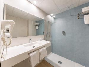 a bathroom with a sink and a mirror at Hotel La Rápita in Sant Carles de la Ràpita +13 photos
