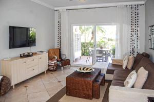 a living room with a couch and a tv at Ocean Dream - Kite Paradise! in Cabarete