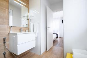 a white bathroom with a sink and a mirror at Alojamento Local Vitoria in Batalha +51 photos