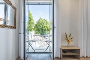 a glass door leading to a balcony with a table at Alojamento Local Vitoria in Batalha