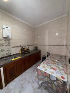 a kitchen with a sink and a table in a room at Samadis Home 3 in Larache