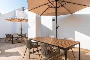 two tables and chairs with umbrellas in a room at Cauce 4 Apartments in Torremolinos