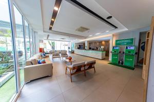a lobby of a hospital with a couch and chairs at Ecco Hotel Fortaleza in Fortaleza
