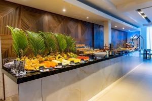 a buffet line with fruits and vegetables on display at Ecco Hotel Fortaleza in Fortaleza