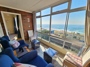 a living room with a view of the ocean at On The Beach Scottburgh in Scottburgh
