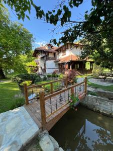 a bridge over a river in front of a house at Vodenica kod Uče in Gukoš