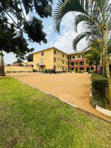 an empty parking lot in front of a building at Ebenezer resort hotel in Mbale