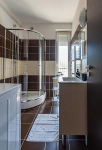 a bathroom with a shower and a sink and a tub at Six Corners Mystic Corner City View Balcony Apartment in Pécs +12 photos