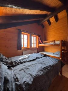 a bedroom with two bunk beds in a cabin at Mountain hut 'la Fraccia' in Trasquera