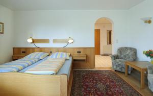 a bedroom with a bed and a table and a chair at Düne, App 12 in Duhnen