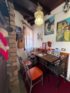 a dining room with a table and chairs and a guitar at Hava Baci (old town) in Berat