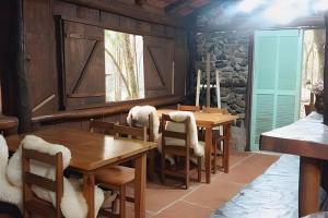 a dining room with wooden tables and chairs at Cabana surucuã in Três Coroas