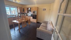 a living room with a couch and a table in a kitchen at The Cloverhill House in Mullaghbane