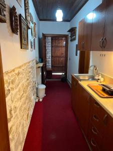 a kitchen with a red carpet in a room at Hava Baci (old town) in Berat +40 photos