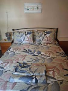 a bed with a colorful comforter and pillows at Kalyves Beach in Kalives Poligirou