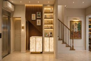 a hallway with a staircase with a shelf and a stair case at Hôtel Beauvoisin in Paris