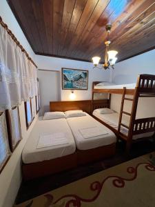 a bedroom with two beds and a bunk bed at Hava Baci (old town) in Berat
