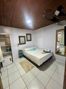 a bedroom with a bed and a mirror in it at Recanto do Sol I in Ilha do Mel +13 photos