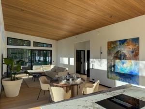 a living room with a couch and a table at Jõelähtme Golf Villa with Sauna and Terrace Grill - near EGCC Golf Course in Manniva