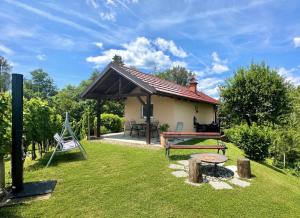 a small house with a bench and a table at Tomajna Vineyard Stay in Podlehnik