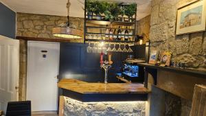 a bar in a restaurant with a stone wall at Amble Harbour retreats in Amble