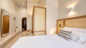 a bedroom with a large white bed and a window at Cosy Rooms Tapinería in Valencia +37 photos