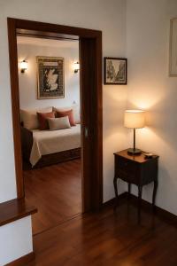 a bedroom with a bed and a door with a mirror at Casa do Lavadouro in Paços de Gaiolo +19 photos