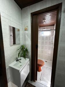 a bathroom with a toilet and a sink at Recanto do Sol I in Ilha do Mel